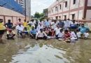 धनबाद में बीच सड़क पर गंदे पानी में स्थानीय लोगों के साथ सत्याग्रह पर बैठे विधायक